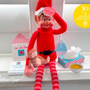 May include: A red elf doll wearing a red and white striped hat with a heart-shaped bandage on its forehead. The elf is sitting on a windowsill with a teddy bear, a tissue box, a bowl of soup, and a get well soon card. The card says "Get Well Soon" and has a red cross on it. The tissue box is blue and white with red stripes. The bowl of soup is white with a yellow rim. The elf is holding the teddy bear in its left hand and the get well soon card in its right hand.