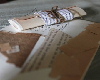 Puede incluir: Un trozo de papel enrollado atado con cuerda y tela, con una nota manuscrita en un trozo de papel debajo. La nota incluye el texto "PORTUGAL".