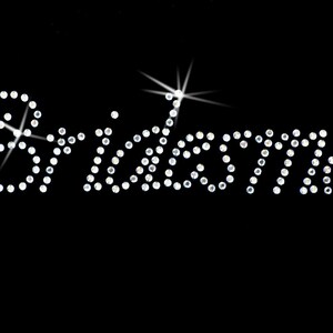 May include: The word "Bridemaid" spelled out in rhinestones on a black background.