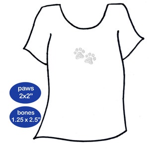 May include: White t-shirt with two paw prints in the center. The text "paws 2x2" and "bones 1.25 x 2.5" is written in blue circles on the bottom left of the image.