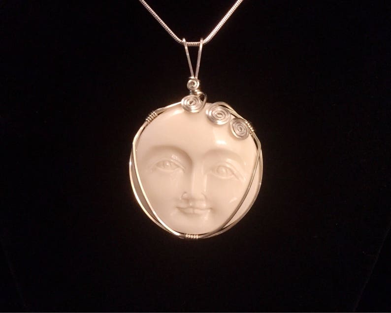 carved bison bone open eyed moon face necklace wire wrapped bison bone face pendant Serene goddess in silver necklace celestial jewelry