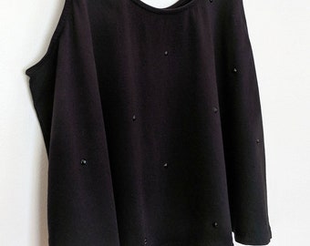 May include: A black sleeveless top with a scoop neck and a slightly flared hem. The top is adorned with small black embellishments.