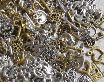 May include: A large collection of silver and gold-toned metal key charms. The charms are in the shape of keys, hearts, and other decorative designs.