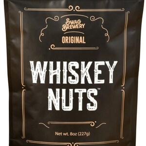 May include: Black bag of "Whiskey Nuts" from Swag Brewery. The bag has a decorative border and the words "Swag Brewery Original" in a vintage style. The net weight is 8oz (227g).
