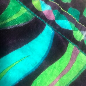 May include: Close-up of a dark blue and green fabric with a wavy pattern. The fabric has a soft, velvety texture. The word "Dundee" is written in white on the fabric.