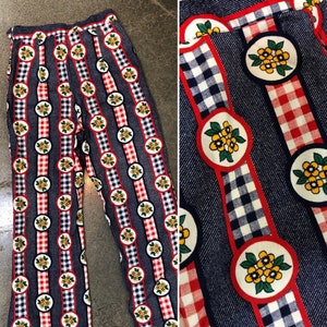 May include: A pair of blue and white striped pants with red and white checkered bands and yellow flower designs.