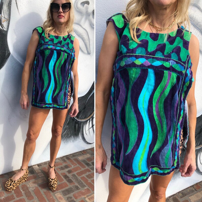 May include: A sleeveless, blue, green, and purple patterned, short, vintage, beach cover-up with a geometric design.