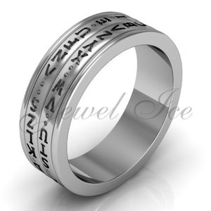 May include: A silver band ring with a black inscription of the Greek alphabet around the band.
