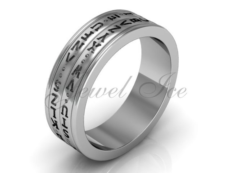 May include: A silver band ring with a black inscription of the Greek alphabet around the band.