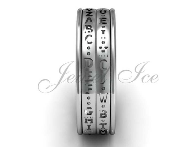 May include: A silver ring with a rotating band that features the alphabet engraved around the edge.