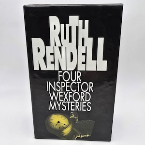 May include: A black book with white text that reads "Ruth Rendell" and "Four Inspector Wexford Mysteries." A gold pocket watch is featured on the bottom of the book. The book is a mystery novel.