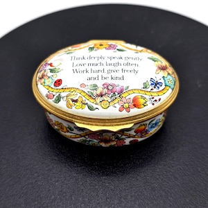 May include: An oval trinket box with a floral pattern and gold edging. The lid is inscribed with the words "Think deeply speak gently. Love much, laugh often. Work hard, give freely and be kind."