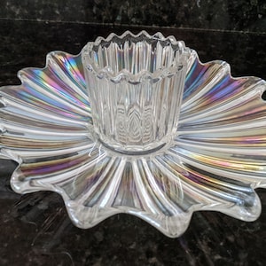 May include: A clear glass serving dish with a raised centre bowl. The dish has a scalloped edge and iridescent rainbow pattern.