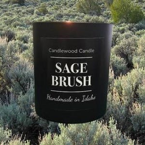 May include: Black candle jar with a white label that reads "Candlewood Candle Sage Brush Handmade in Idaho".
