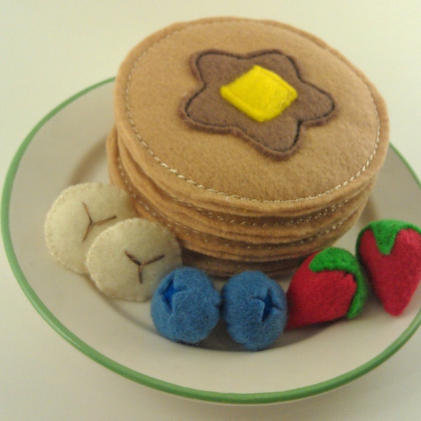 four felt play food pancakes and fruit breakfast- blueberry, strawberry, banana, syrup and butter.