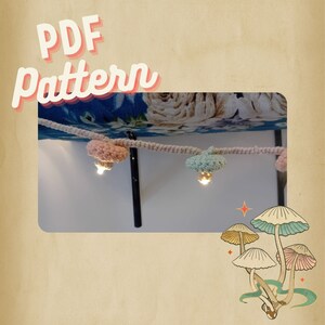 May include: A decorative string of mushroom lights in pastel pink and mint green. The lights are attached to a beige rope and are lit up. The image includes the text "PDF Pattern" in a retro style.