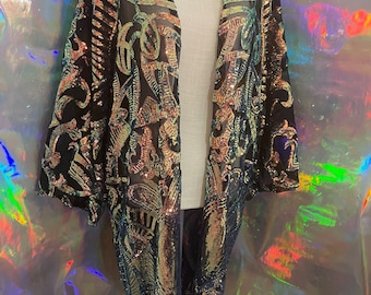 May include: A black sheer kimono with gold and iridescent sequins in a geometric pattern.