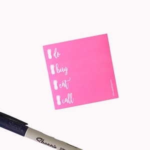 May include: A pink sticky note with a pineapple graphic and the words "do", "buy", "eat", and "call" written in white.