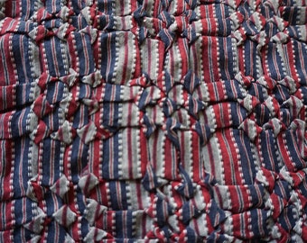 Hand ruched fabric made from red blue grey yarn dyed woven fabric