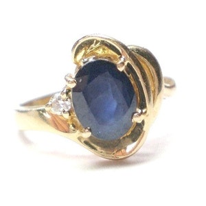 Oval blue sapphire ring in 14k yellow gold w diamond accent, swirl wrap design September birthstone, size 6 !/2 vintage ring, as new