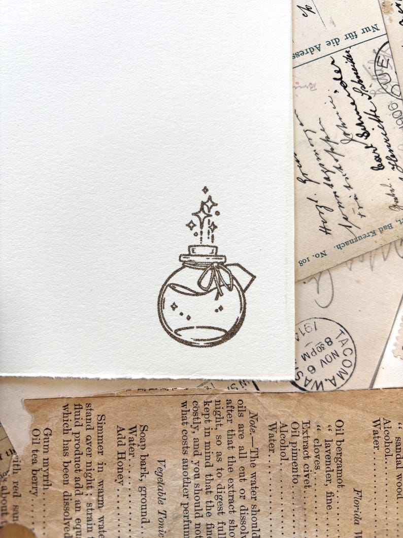 May include: A hand-drawn illustration of a glass bottle with a cork stopper and a ribbon tied around the neck. Stars are coming out of the bottle, suggesting magic or a potion.