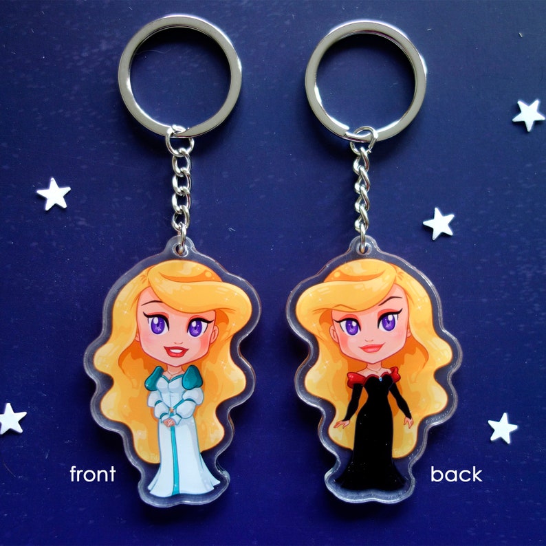 Clear acrylic keychains 6cm with silver ring of Odette and Odile (Swan Princess). In the front Odette wears white dress and in the back Odile wears black dress.