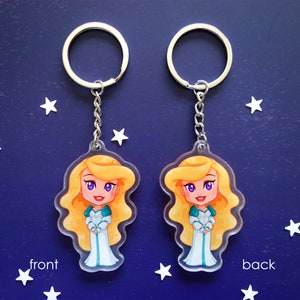 Clear acrylic keychains 6cm with silver ring of Odette (Swan Princess) shown front and back side, with the same print, with white dress.