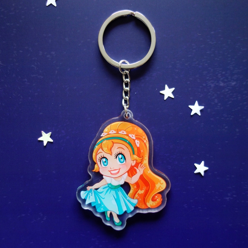 Clear acrylic keychain 6cm with silver ring of Thumbelina holding her skirt.