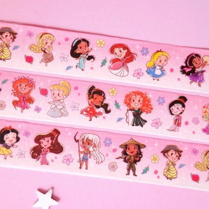 Washi tape with a pattern of mini Disney Princesses on pink background. The pattern shows characters like Raya, Jane, Aurora, Jasmine, Ariel, Alice, Esmeralda, Amelia, Moana, Giselle, Cinderella, Elena, Merida, Mulan, Rapunzel, Tinkerbell...