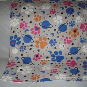Doggy Blanket - dog paws in a celestial background with the same print on the reverse side.
