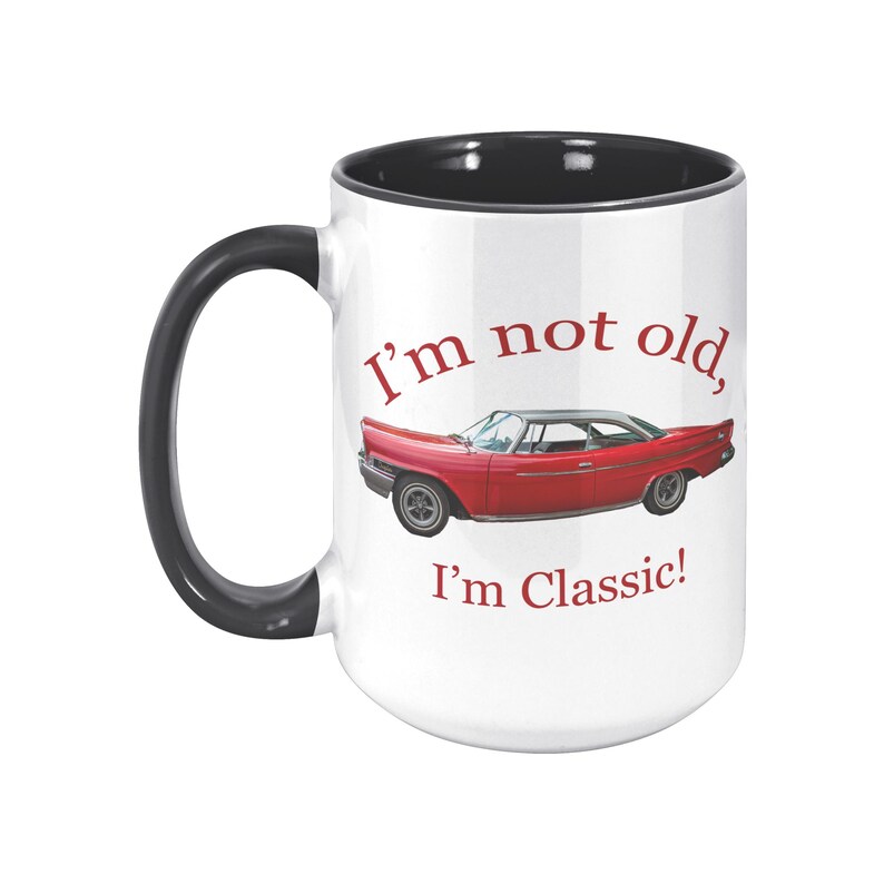 White ceramic mug with vintage 1962 Chrysler 300 photo and 'I'm not old, I'm classic!' quote. Reverse shows '1962 Chrysler 300' text. Options: black, blue, pink, or red handle/interior.