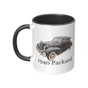May include: White ceramic mug with a black rim and handle. The mug features a black and white image of a 1940 Packard car with the text "1940 Packard" printed below the image.