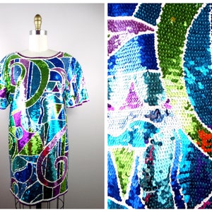 May include: A short-sleeved dress with a geometric pattern made of sequins in shades of blue, green, purple, and white.