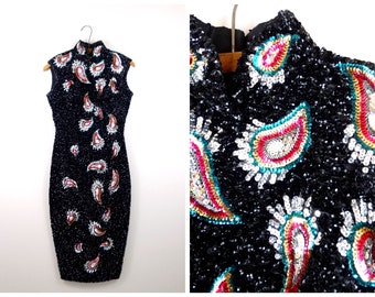 May include: A black sequined dress with a high neck and sleeveless design. The dress is covered in colorful paisley patterns.