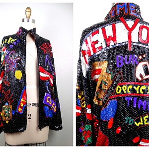 May include: A black sequined jacket with a zipper closure. The jacket is covered in colorful sequins and embroidery, featuring the words "New York" and other phrases.