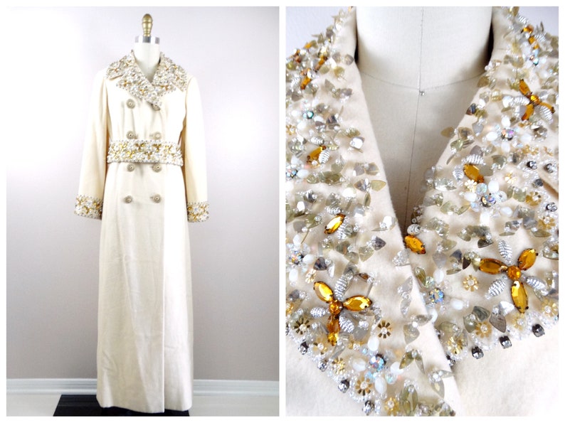 May include: A long white coat with a double breasted closure and a large embellished collar and cuffs. The embellishments are made of gold and silver beads, sequins, and rhinestones.