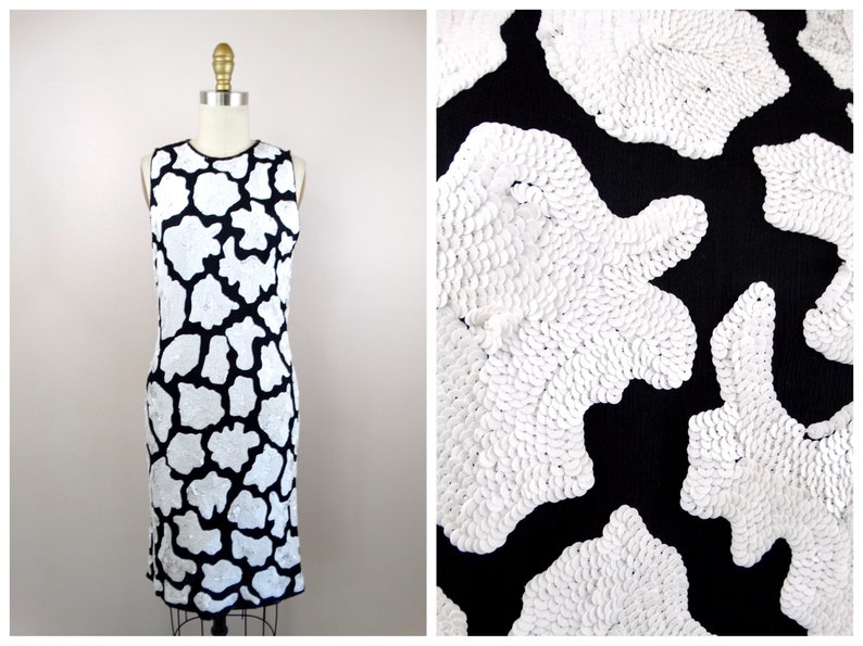May include: A sleeveless black dress with a white abstract pattern. The pattern is made of small, round sequins.