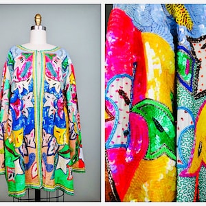 May include: A colorful sequined jacket with a floral and geometric design. The jacket is made of a light fabric and has a long, flowing silhouette.