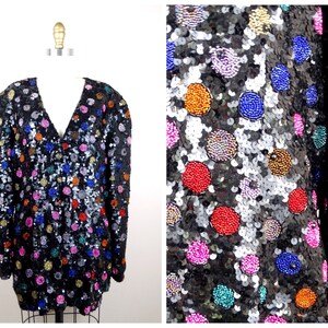 May include: A black sequined jacket with colorful polka dots. The jacket has a V-neck and long sleeves.