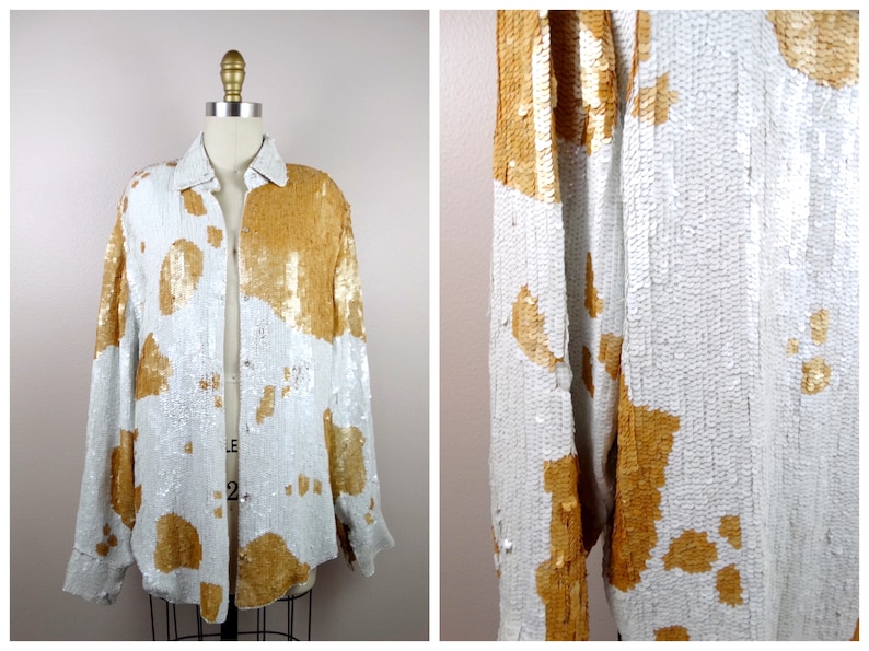 May include: A white and gold sequined jacket with a button-up front. The jacket has a cowhide pattern.