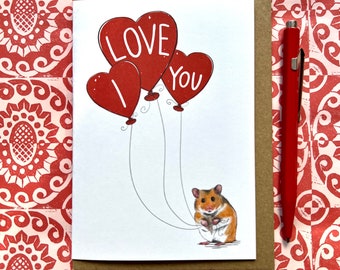 May include: A card with a hamster holding three red heart-shaped balloons that say "I Love You".