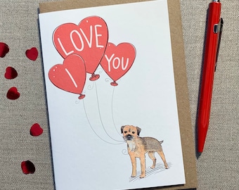 May include: A Valentine's Day card featuring a brown and tan Border Terrier holding three red heart-shaped balloons. The balloons are printed with the words "I LOVE YOU".