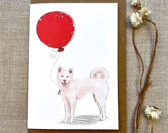 May include: A white dog with a red balloon tied to its mouth. The dog is standing on a white background with black stripes.