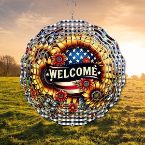 May include: A metal wind spinner with a layered design featuring sunflowers, an American flag, and the word "WELCOME". The spinner is painted in shades of red, white, blue, yellow, and green.