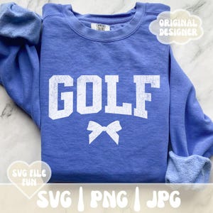 May include: A blue sweatshirt with the word "GOLF" in white distressed lettering and a white bow. The sweatshirt has a crew neck and long sleeves.