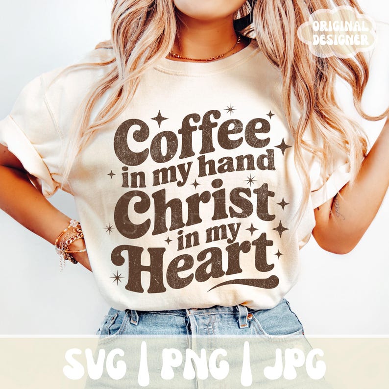 May include: Cream-colored t-shirt with the text "Coffee in my hand, Christ in my Heart" in brown, retro-style lettering. The design includes star accents. The bottom of the shirt shows the text "SVG | PNG | JPG".