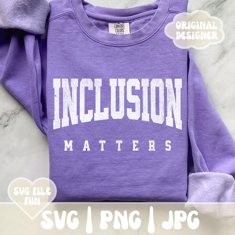 May include: Purple sweatshirt with the text "INCLUSION MATTERS" in white. The sweatshirt is a blank canvas for a design.