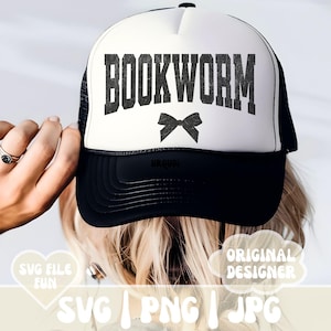 May include: A white trucker hat with a black mesh back. The front of the hat has the text "BOOKWORM" in black with a black bow underneath.