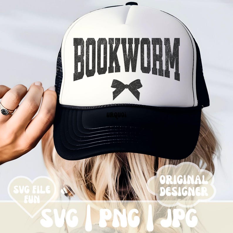 May include: A white trucker hat with a black mesh back. The front of the hat has the text "BOOKWORM" in black with a black bow underneath.
