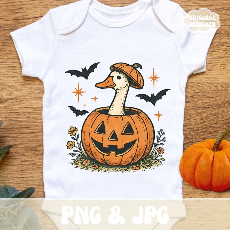 May include: White baby onesie with a Halloween-themed graphic. The design features a duck wearing a pumpkin hat and emerging from a carved pumpkin. Black bats and stars surround the duck and pumpkin. The words "PNG & JPG" are at the bottom.
